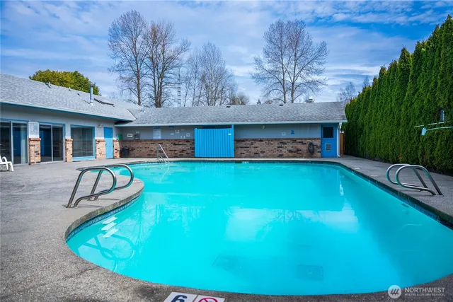 a swimming pool with outdoor seating and yard