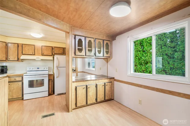 a kitchen with a stove a sink and a microwave