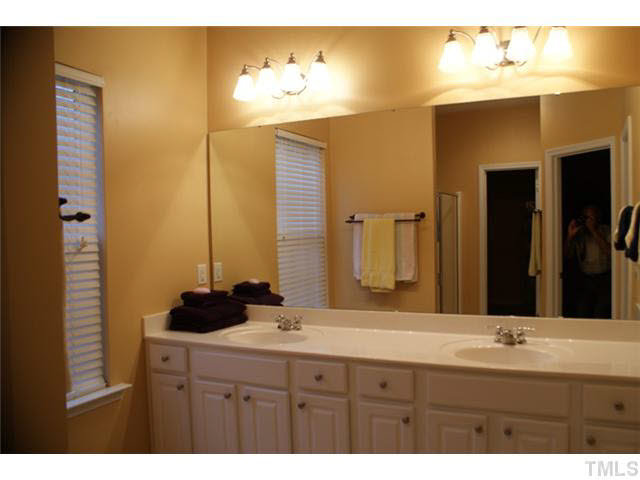 3413 Cathedral Bell Road Raleigh, NC 27614 - Photo 13 of 22 a bathroom with a double vanity sink and a mirror