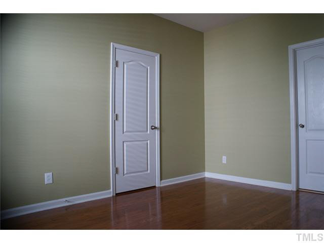 3413 Cathedral Bell Road Raleigh, NC 27614 - Photo 14 of 22 a view of an empty room with closet and wooden floor