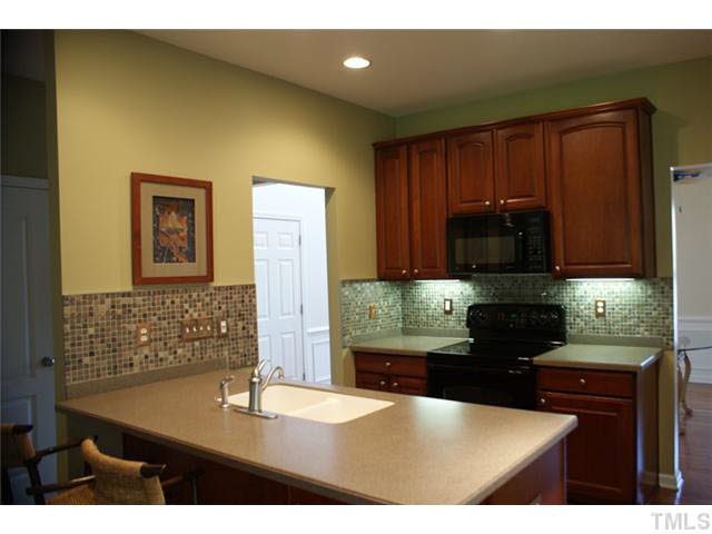 3413 Cathedral Bell Road Raleigh, NC 27614 - Photo 6 of 22 a kitchen with stainless steel appliances granite countertop a refrigerator a stove top oven with a sink and dishwasher