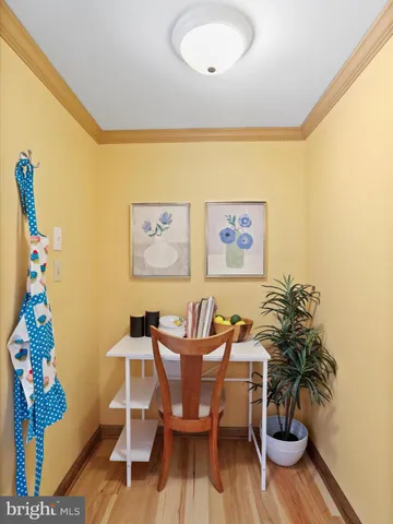 a view of a dining room with furniture a chandelier and wooden floor