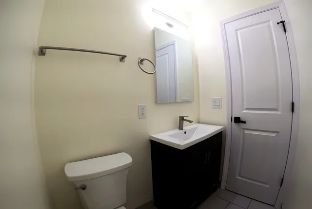 a bathroom with a sink toilet and mirror