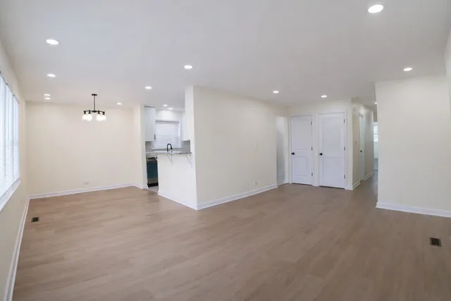 a view of an empty room with a kitchen