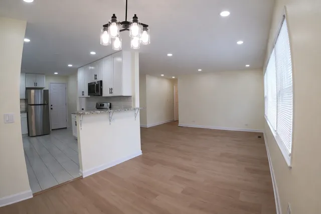 a view of a kitchen with a sink and a refrigerator
