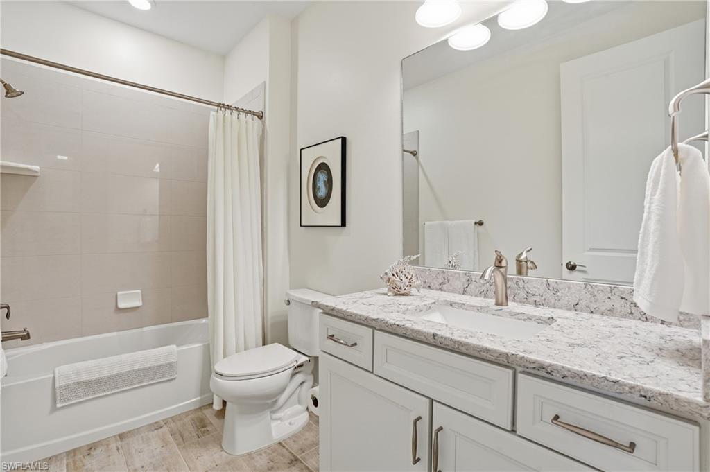 17210 Ashcomb Way Estero, FL 33928 - Photo 29 of 47 a bathroom with a granite countertop sink toilet and shower