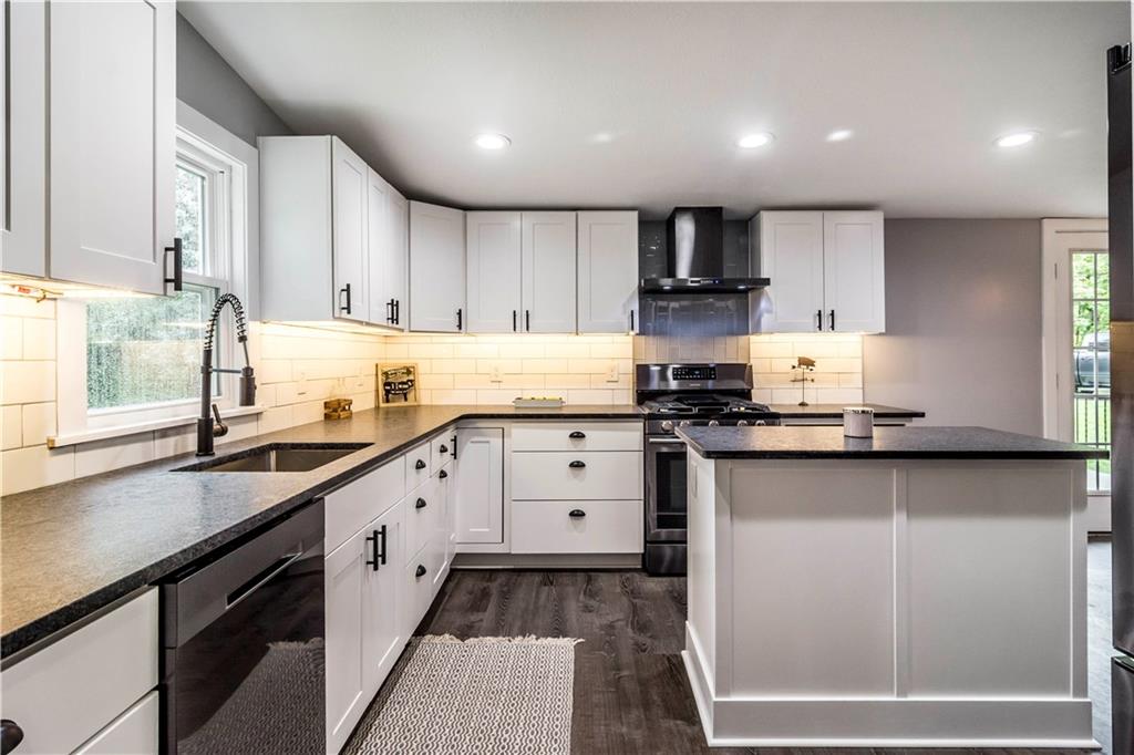 364 Moon Clinton Road Coraopolis, PA 15108 - Photo 7 of 25 a kitchen with granite countertop a sink stove and cabinets