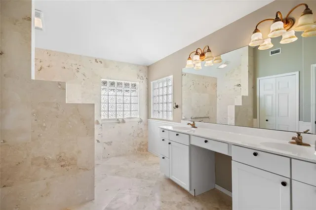 a view of a room with a ceiling fan and a window