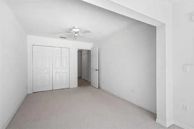 a bathroom with a toilet a sink a mirror a window and vanity