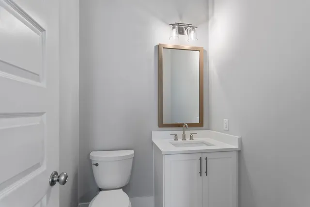 a bathroom with a granite countertop sink a shower and a mirror