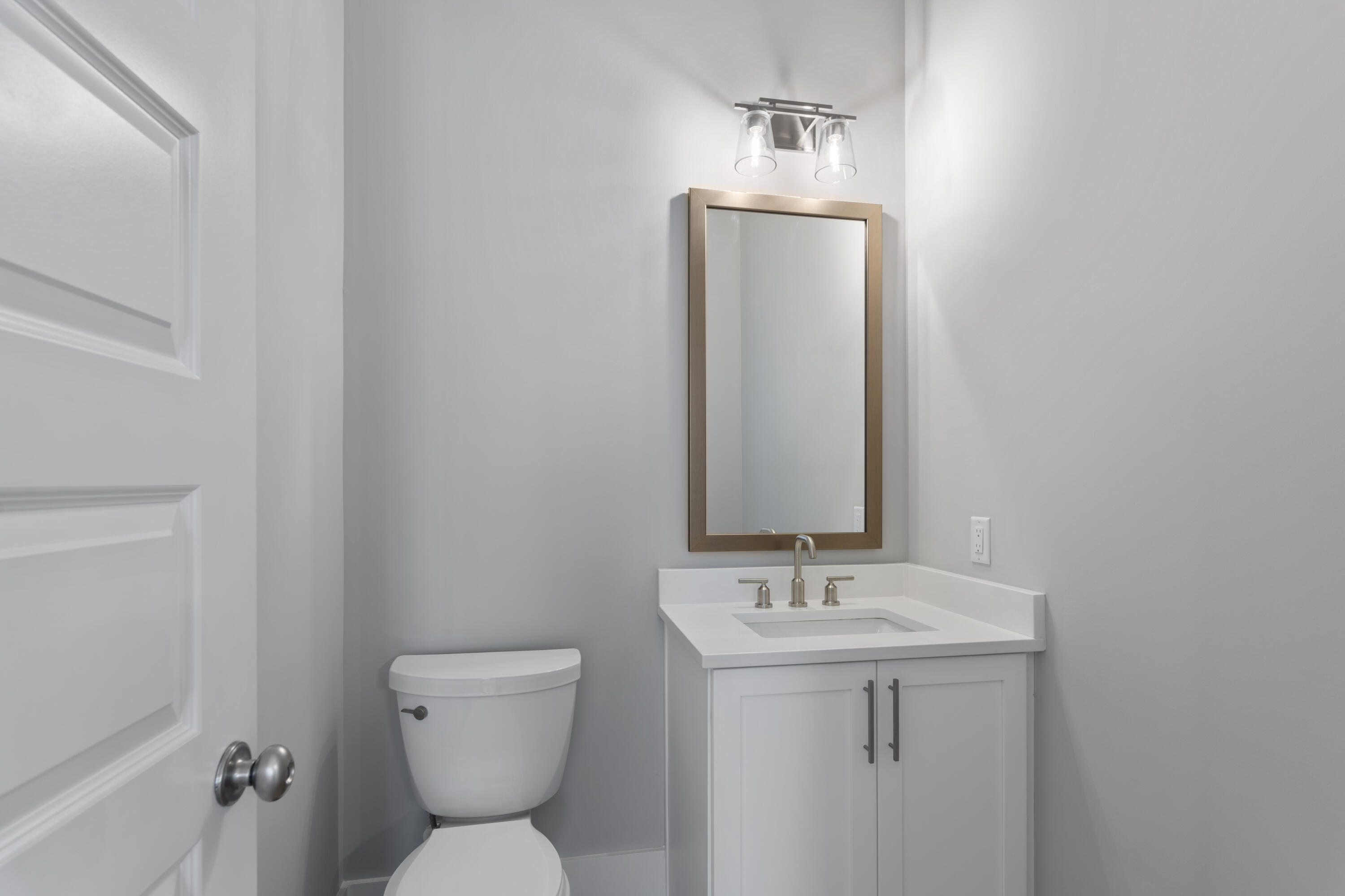 21 West Queen Palm Dr Inlet Beach Inlet Beach, FL 32461 - Photo 35 of 85 a bathroom with a toilet sink and mirror