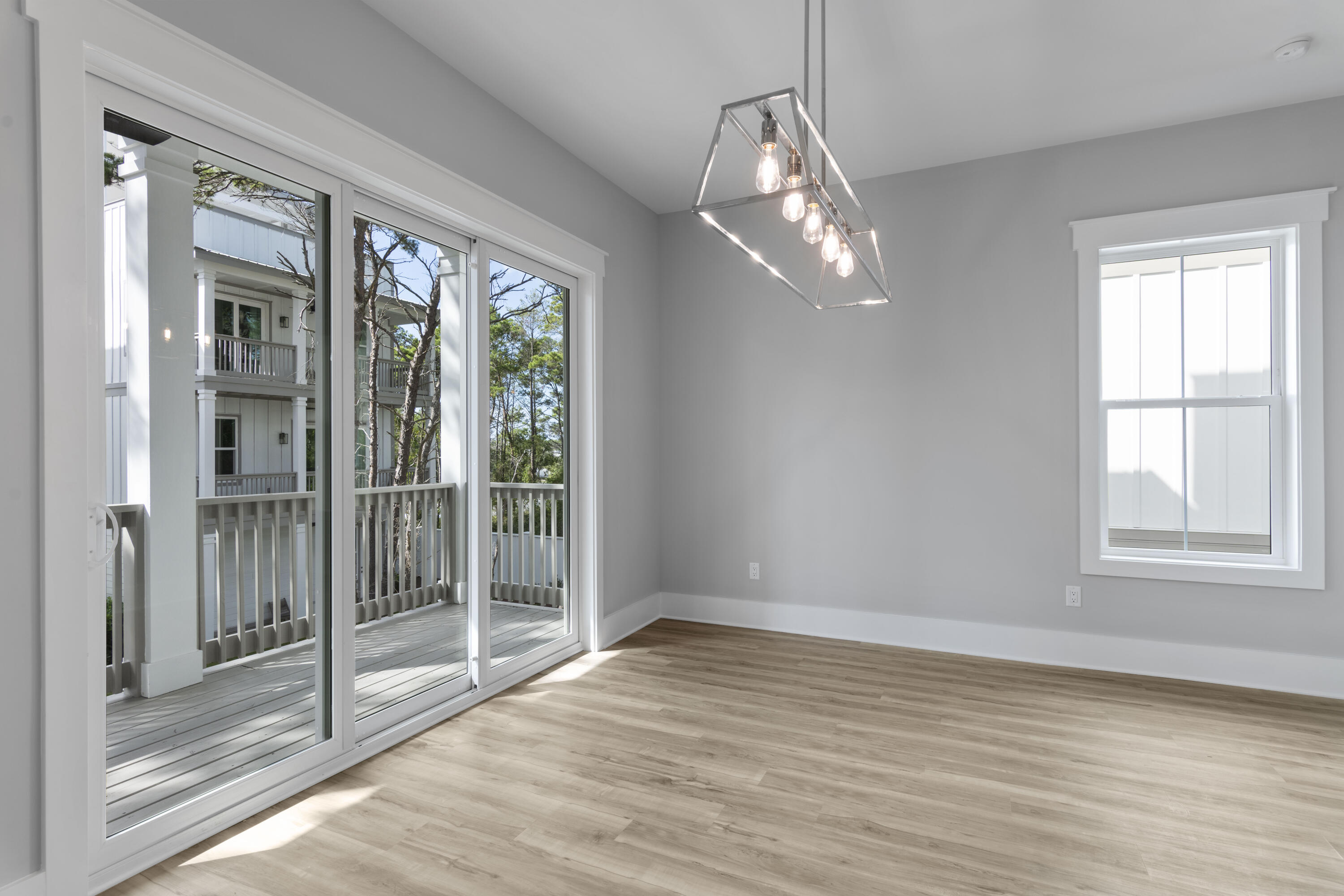 21 West Queen Palm Dr Inlet Beach Inlet Beach, FL 32461 - Photo 37 of 85 a view of an empty room with wooden floor and a window
