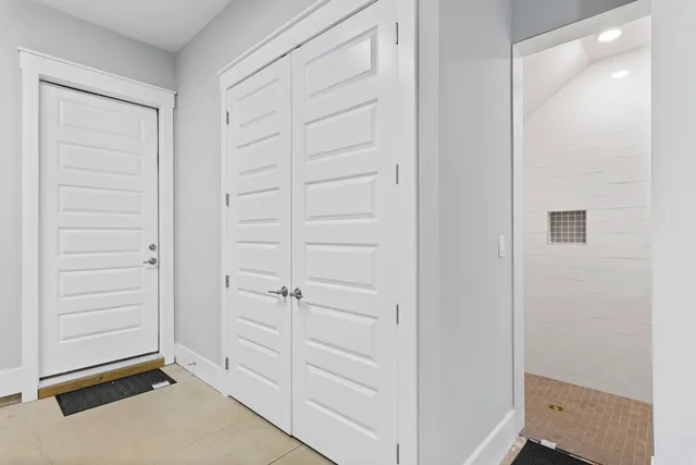 an empty room with windows and closet