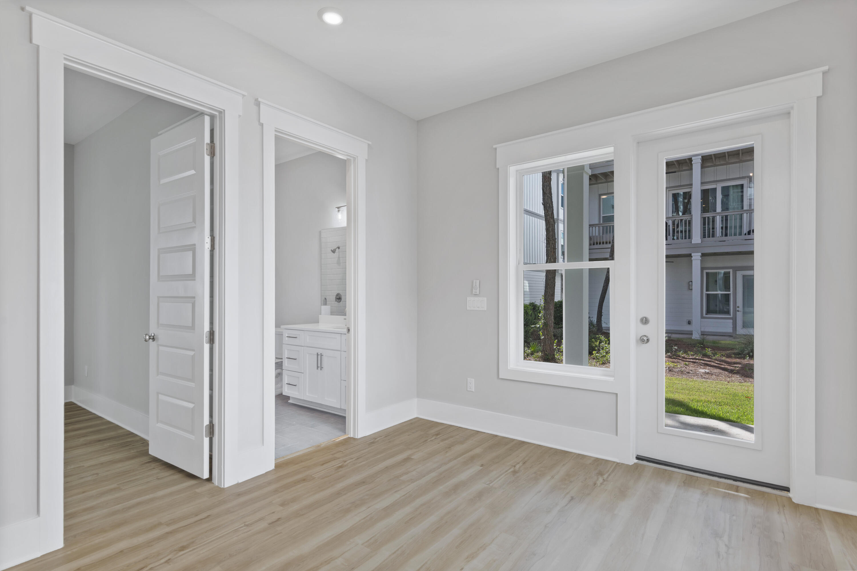 21 West Queen Palm Dr Inlet Beach Inlet Beach, FL 32461 - Photo 9 of 85 a view of an empty room with window and wooden floor