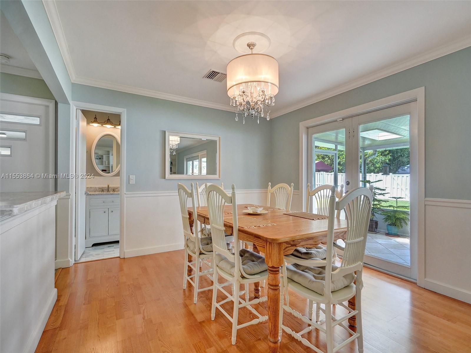 3445 Fillmore Street Hollywood, FL 33021 - Photo 19 of 76 a view of a dining room with furniture wooden floor and chandelier