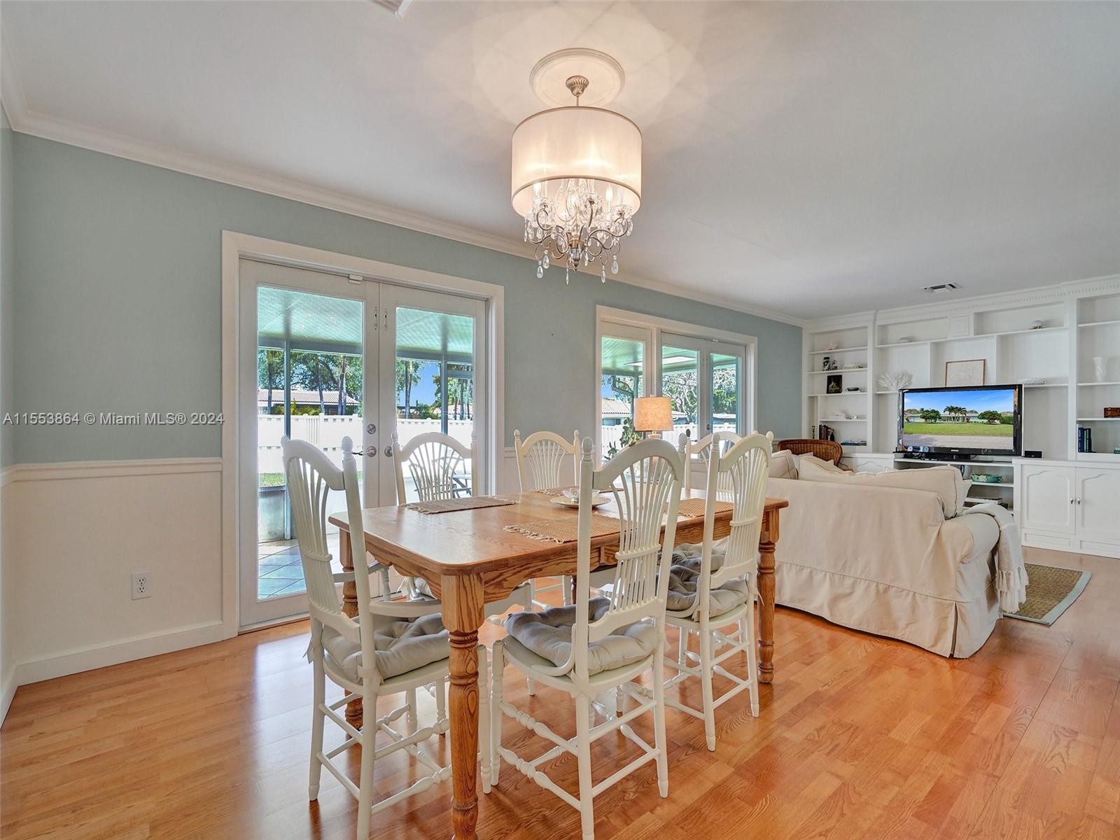 3445 Fillmore Street Hollywood, FL 33021 - Photo 20 of 76 a view of a dining room with furniture wooden floor and chandelier