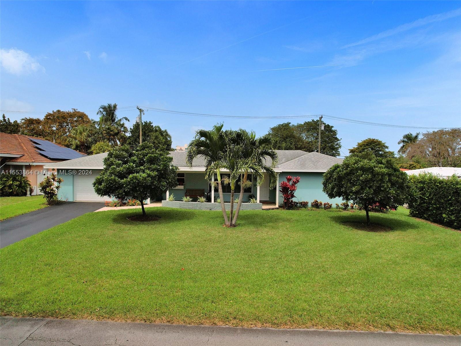 3445 Fillmore Street Hollywood, FL 33021 - Photo 2 of 76 a house with garden in front of it