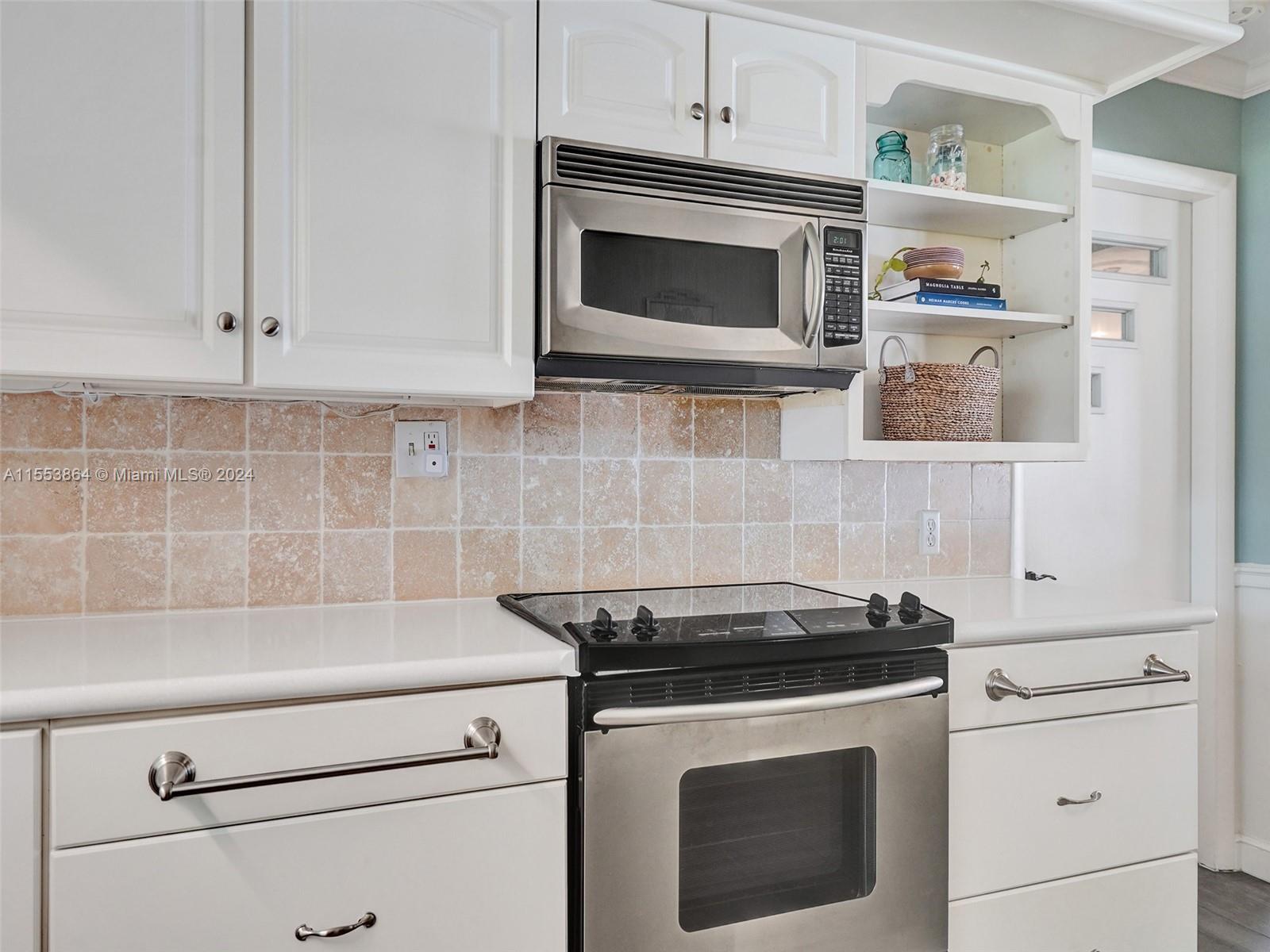 3445 Fillmore Street Hollywood, FL 33021 - Photo 25 of 76 a kitchen with stainless steel appliances granite countertop white cabinets and a stove