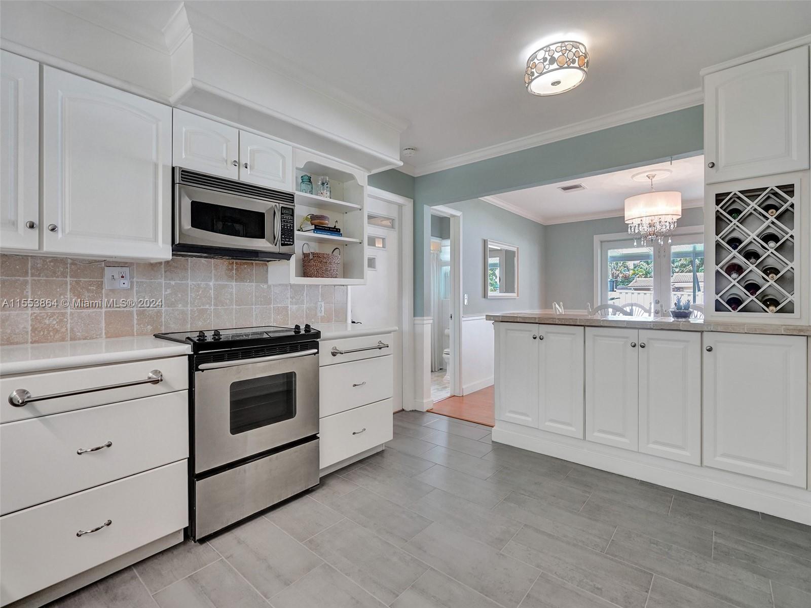 3445 Fillmore Street Hollywood, FL 33021 - Photo 26 of 76 a kitchen with white cabinets and appliances