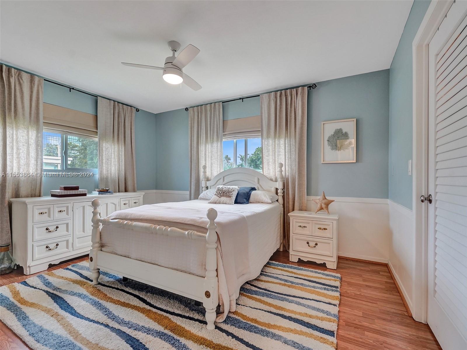 3445 Fillmore Street Hollywood, FL 33021 - Photo 31 of 76 a spacious bedroom with a bed and a chandelier