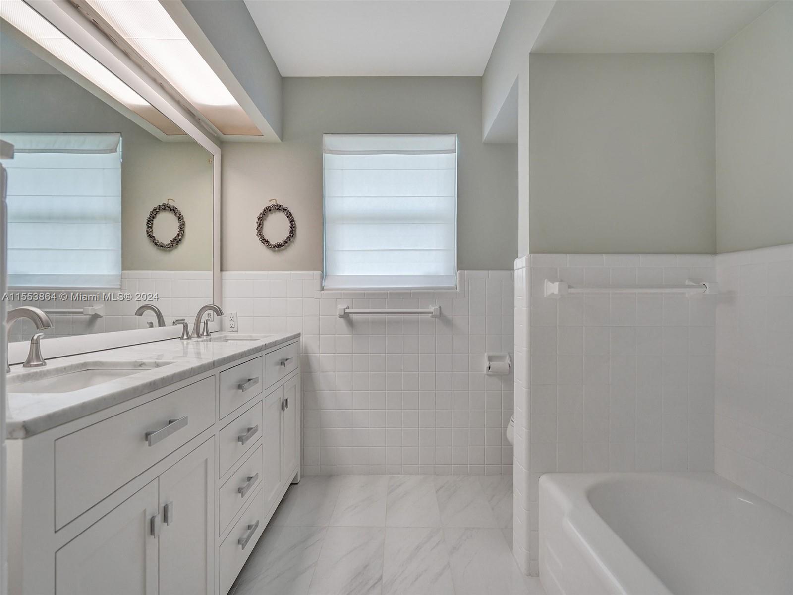3445 Fillmore Street Hollywood, FL 33021 - Photo 36 of 76 a bathroom with a granite countertop sink and a mirror
