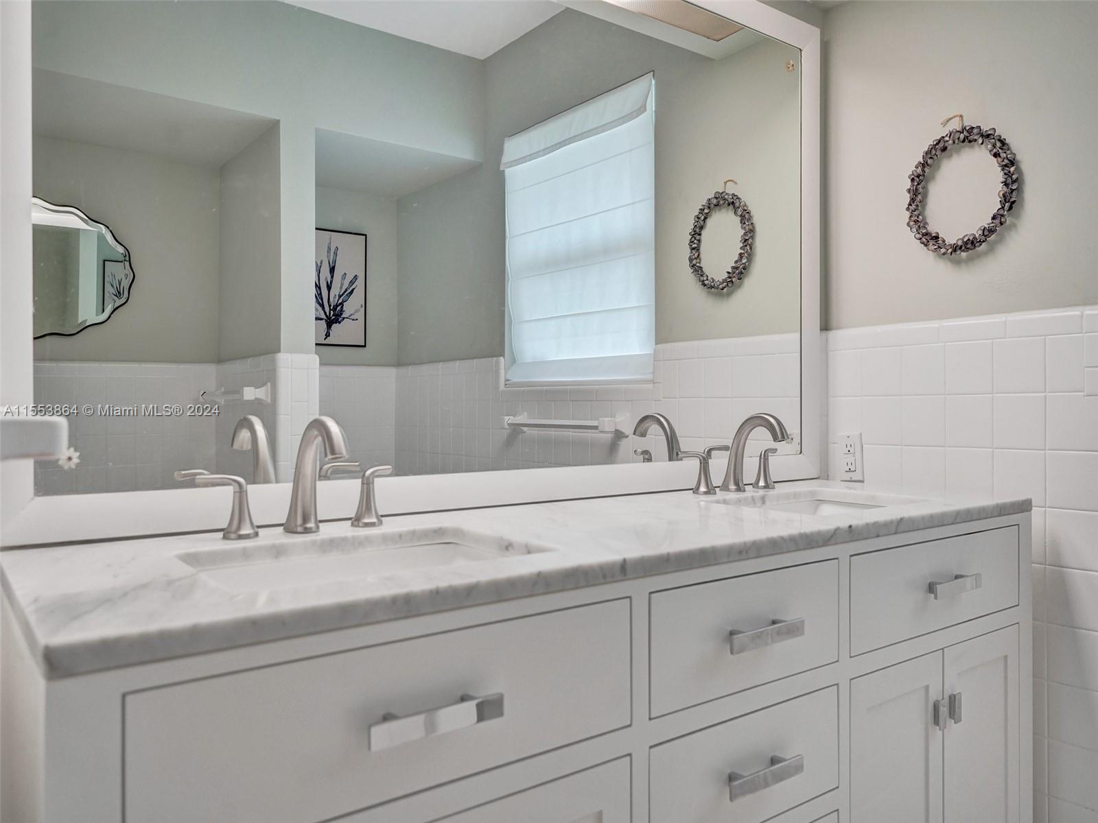 3445 Fillmore Street Hollywood, FL 33021 - Photo 37 of 76 a bathroom with cabinets two sinks and a mirror