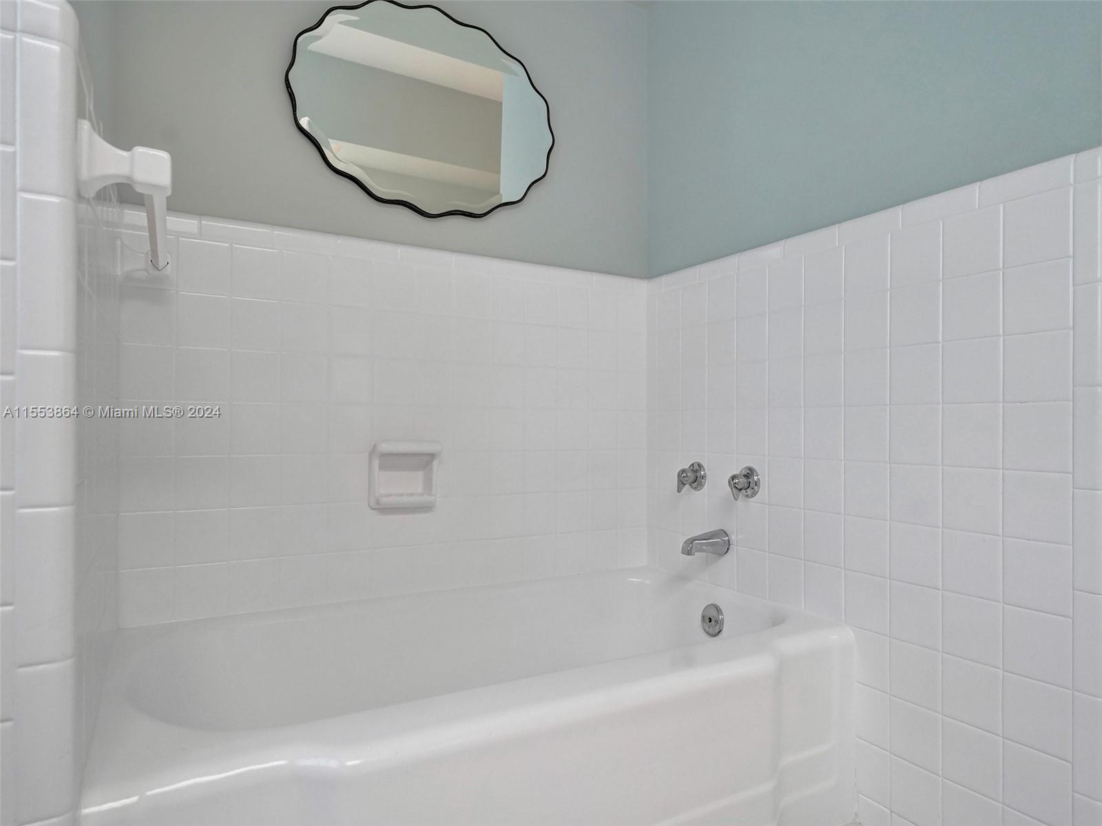 3445 Fillmore Street Hollywood, FL 33021 - Photo 38 of 76 a bathroom with a bathtub and a shower