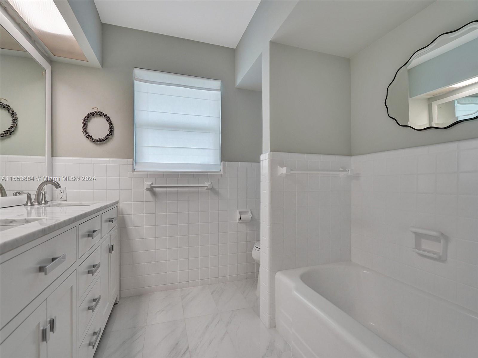 3445 Fillmore Street Hollywood, FL 33021 - Photo 40 of 76 a bathroom with a tub sink and mirror
