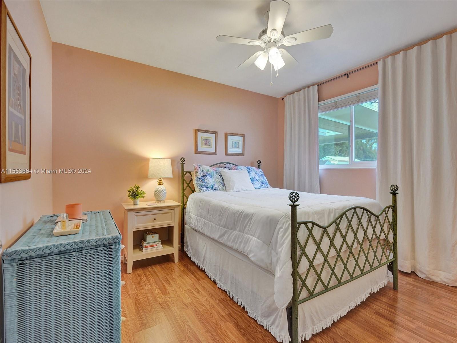 3445 Fillmore Street Hollywood, FL 33021 - Photo 41 of 76 a bedroom with a bed and a chandelier