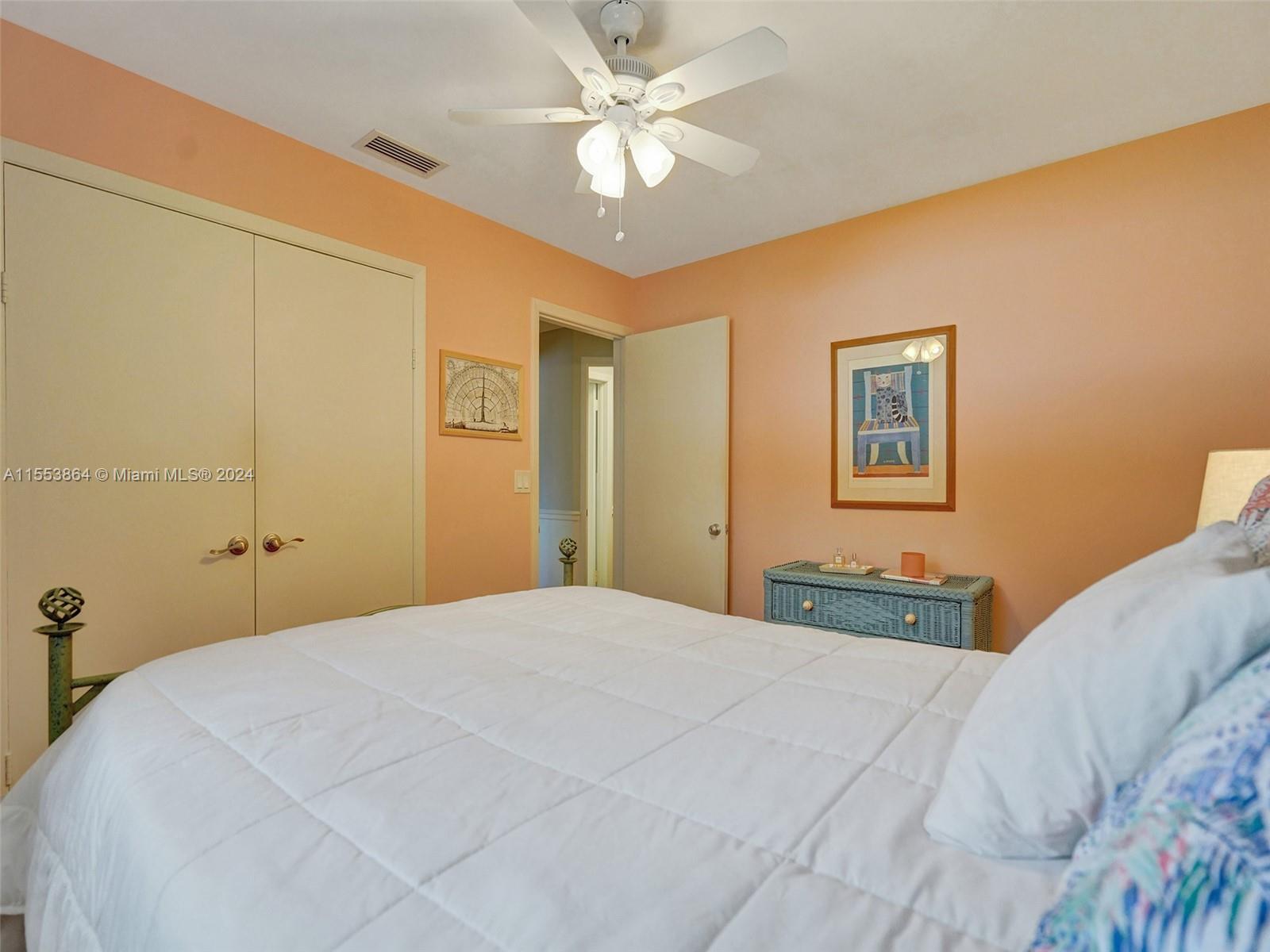 3445 Fillmore Street Hollywood, FL 33021 - Photo 43 of 76 a bedroom with a large bed and a chandelier