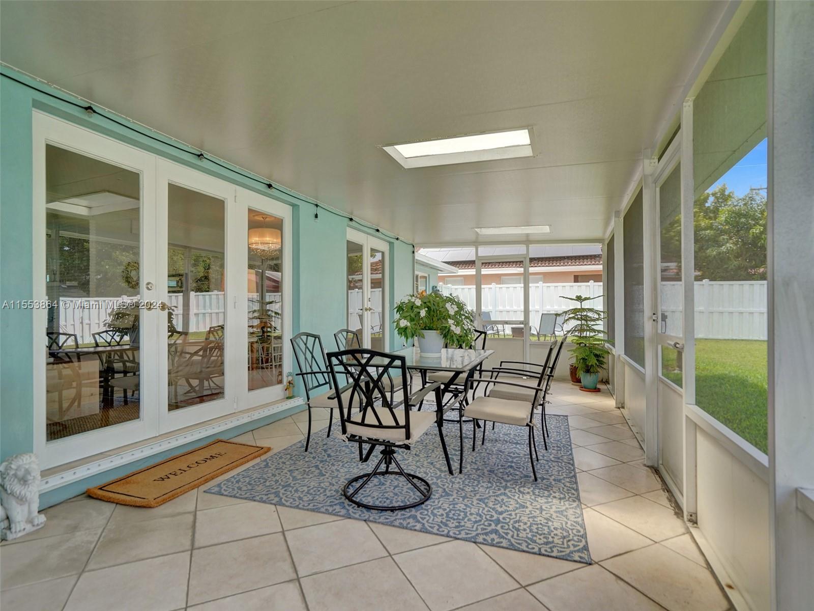 3445 Fillmore Street Hollywood, FL 33021 - Photo 54 of 76 a dining room with furniture and a floor to ceiling window