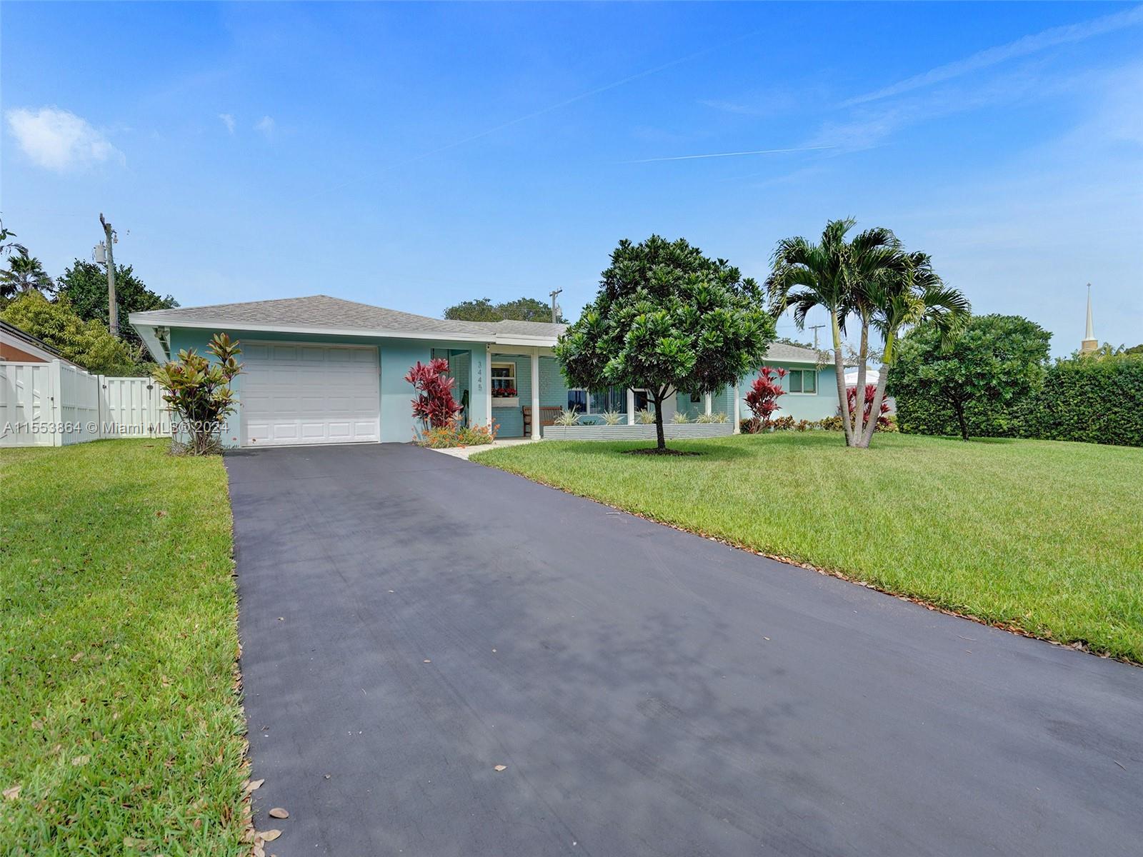 3445 Fillmore Street Hollywood, FL 33021 - Photo 68 of 76 a view of a house with a yard and palm trees