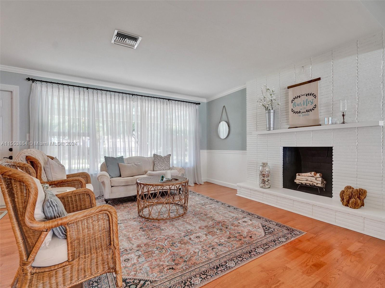 3445 Fillmore Street Hollywood, FL 33021 - Photo 10 of 76 a living room with furniture and a fireplace