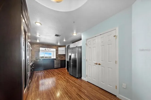 a kitchen with stainless steel appliances a refrigerator and a stove