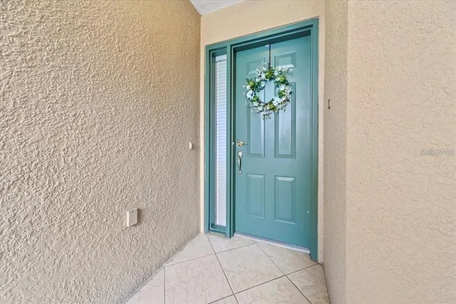 a large kitchen with a large counter top a sink stainless steel appliances and cabinets