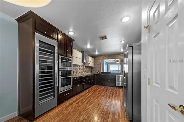 a kitchen with a sink and wooden cabinets
