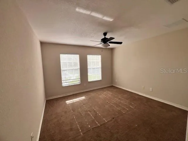a view of an empty room and a window