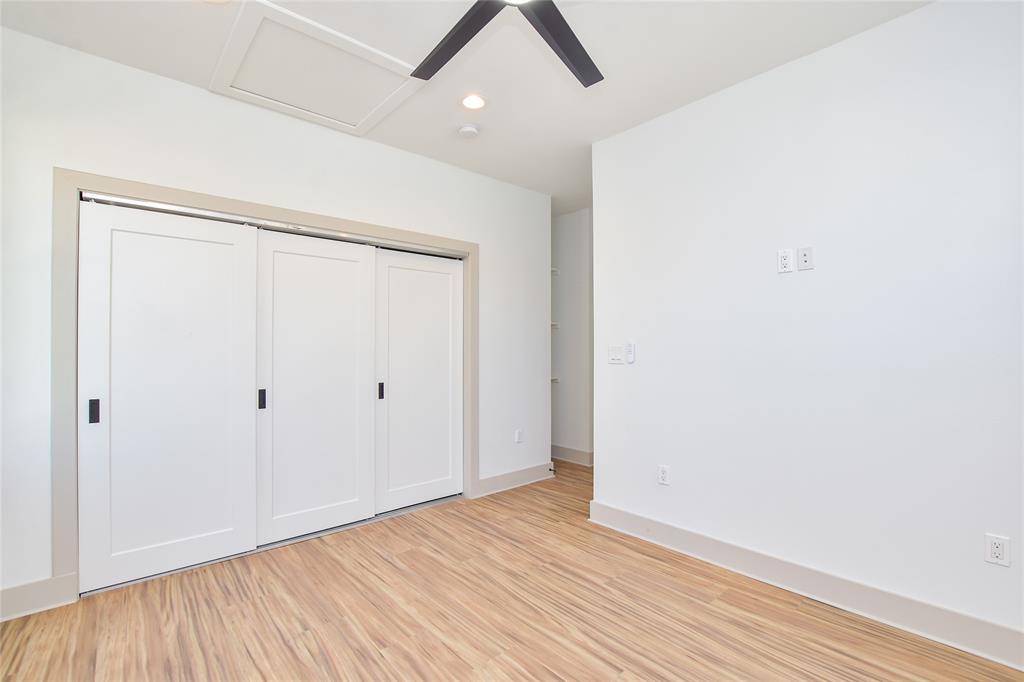 7103 Bennett Avenue, Unit 2 Austin, TX 78752 - Photo 14 of 19 an empty room with wooden floor and a ceiling fan
