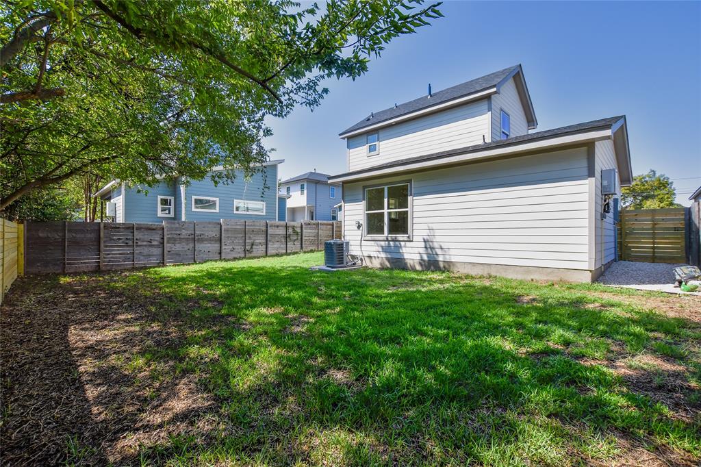 7103 Bennett Avenue, Unit 2 Austin, TX 78752 - Photo 17 of 19 a front view of a house with a garden and yard