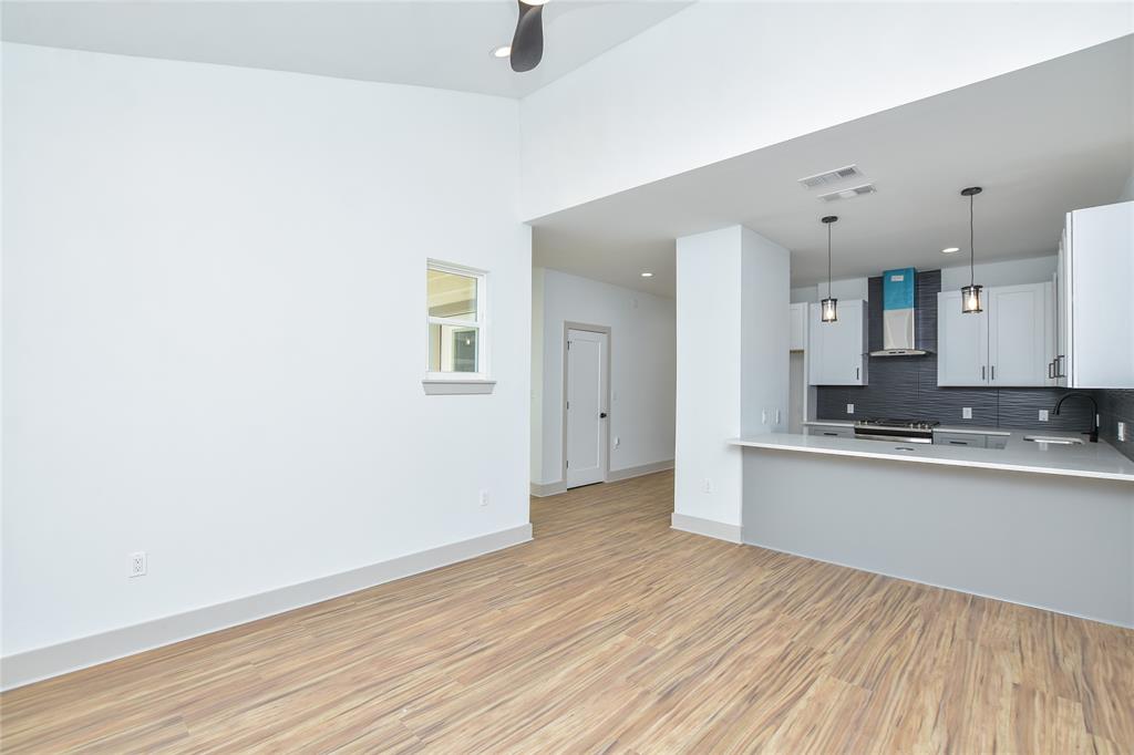 7103 Bennett Avenue, Unit 2 Austin, TX 78752 - Photo 6 of 19 a view of a kitchen with wooden floor and a window