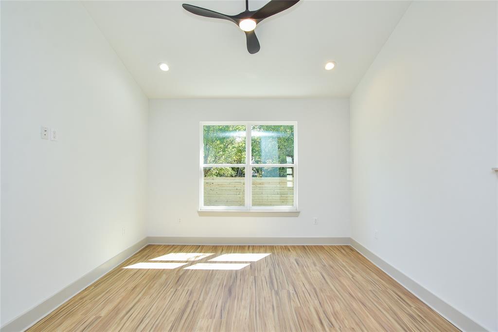 7103 Bennett Avenue, Unit 2 Austin, TX 78752 - Photo 8 of 19 an empty room with wooden floor and windows