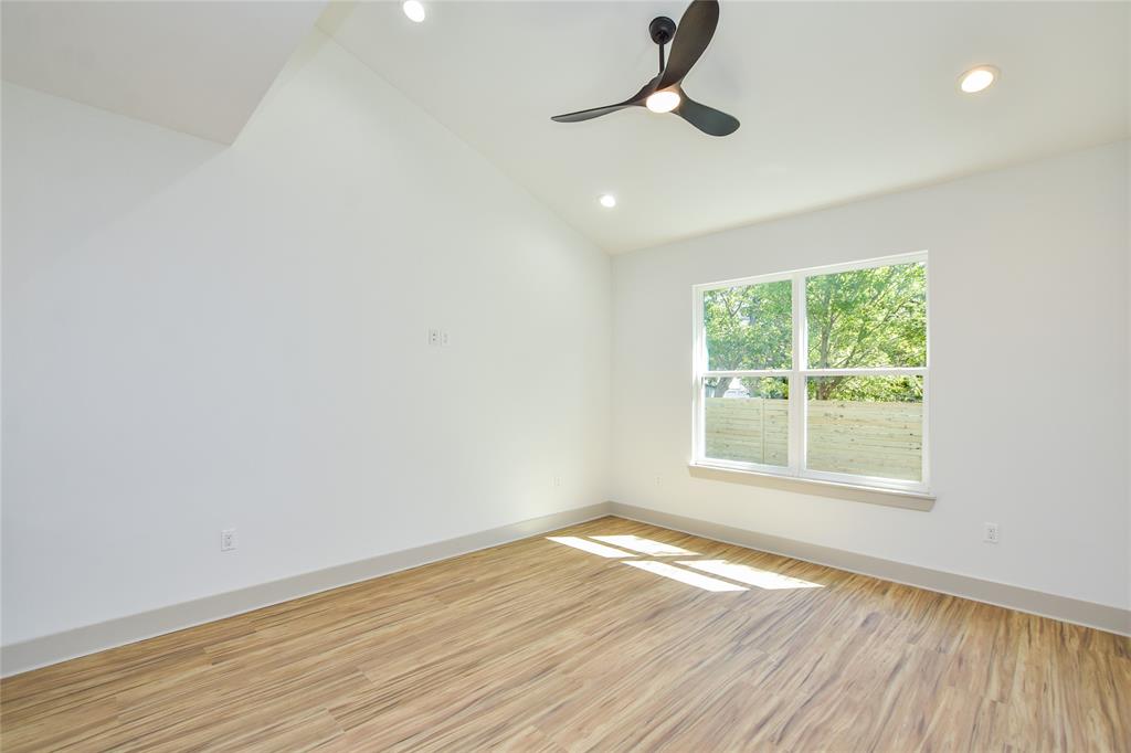 7103 Bennett Avenue, Unit 2 Austin, TX 78752 - Photo 9 of 19 an empty room with wooden floor and windows