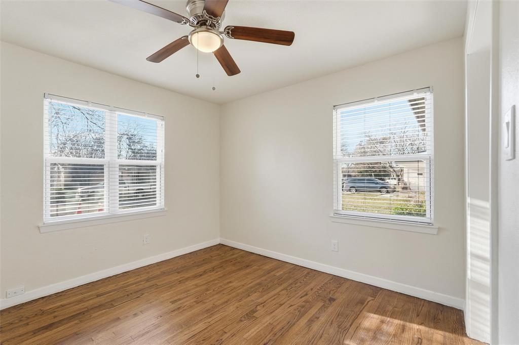 10833 Ruth Ann Drive Dallas, TX 75228 - Photo 11 of 17 a view of an empty room with wooden floor and a window