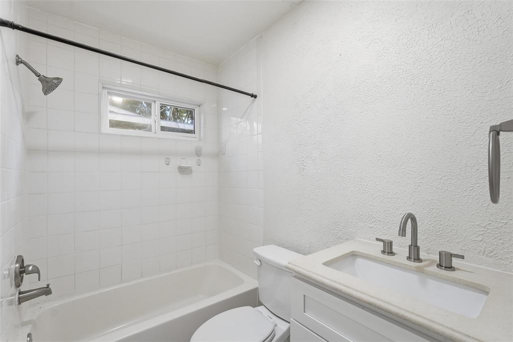 10833 Ruth Ann Drive Dallas, TX 75228 - Photo 12 of 17 a bathroom with a sink toilet and a bathtub