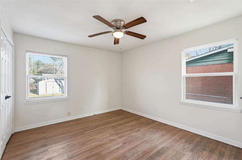 10833 Ruth Ann Drive Dallas, TX 75228 - Photo 13 of 17 a view of an empty room with wooden floor and a window