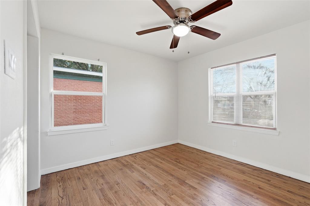 10833 Ruth Ann Drive Dallas, TX 75228 - Photo 14 of 17 a view of an empty room with wooden floor and a window