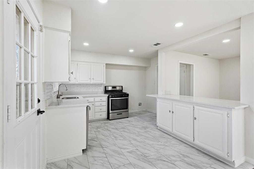 10833 Ruth Ann Drive Dallas, TX 75228 - Photo 6 of 17 a kitchen with stainless steel appliances granite countertop a stove and a refrigerator