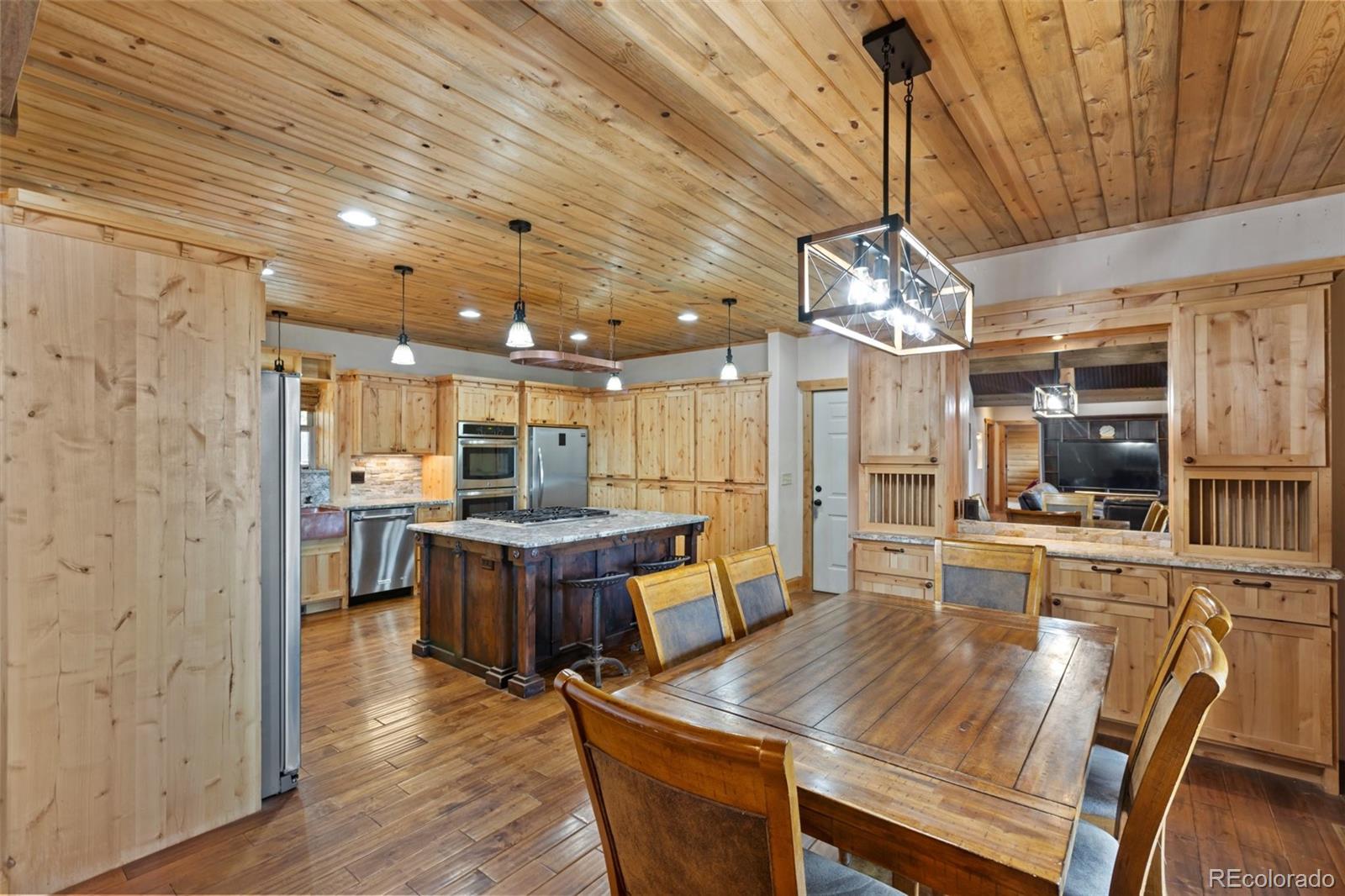 111 Blue Spruce Road Divide, CO 80814 - Photo 15 of 46 a large kitchen with a table and chairs