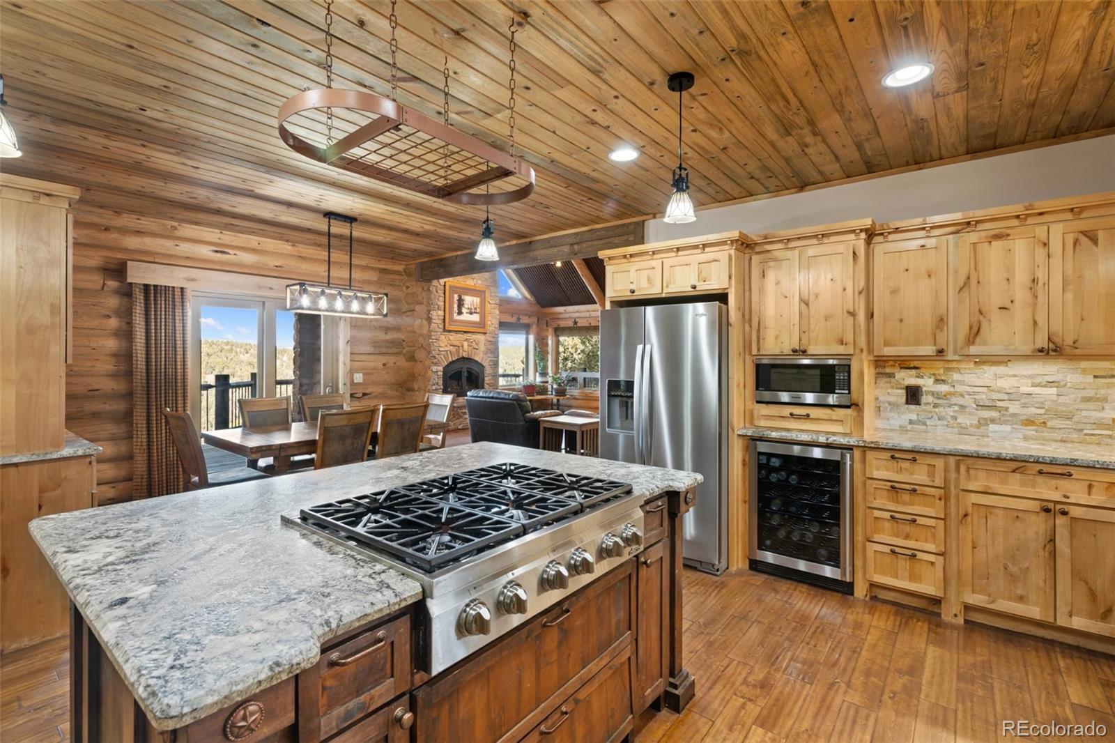 111 Blue Spruce Road Divide, CO 80814 - Photo 16 of 46 a kitchen with a stove a refrigerator and wooden floor