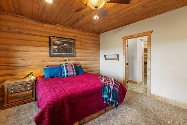 a bed sitting in a bedroom next to a lamp